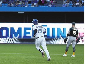 Chris Colabello of the Blue Jays circles the bases after hitting a three-run home run in the first inning Wednesday as Brett Lawrie of the Athletics looks on.