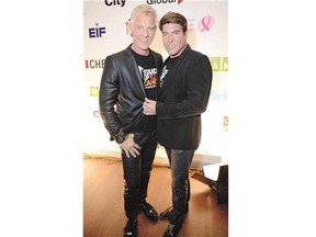 Chris Hyndman, right, shown in Toronto last September with his spouse and CBC co-host, Steven Sabados, was found dead in an alley in east-end Toronto late Monday, below the terraced condo unit that the couple shared.