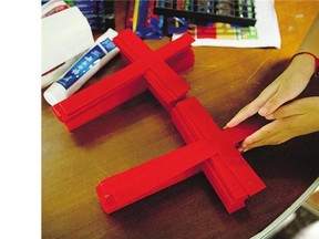 A church member arranges crosses after Chinese government agents cut down the building's cross.