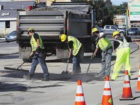 City crews repair a section of road on Eighth Street in Saskatoon.