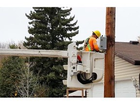 A city worker installs a smart meter on Woodward Avenue on Thursday afternoon. City officials say there is no concern about the meters, which are currently being installed across the city, malfunctioning once installed and operational.