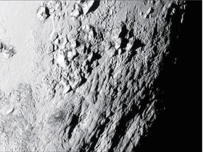 A close-up image of a region near Pluto's equator shows a range of mountains rising as high as 3,500 metres. The image was captured by NASA's New Horizons spacecraft as it passed by the dwarf planet on Tuesday.