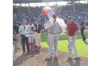 Cole Hamels of the Philadelphia Phillies gets an ice water bath after his no-hitter on Saturday at Wrigley Field in Chicago.