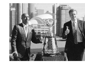 CFL Commissioner Jeffrey Orridge, left, and Toronto Mayor John Tory pose with the Grey Cup while announcing Toronto as the host of the 2016 Grey Cup on Thursday.