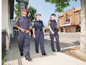 Community support officers, Jonathan Keens-Douglas, left, Lesley Prefontaine and Krista Townsend can be seen on 20th Street in Saskatoon July 11, 2012. (Richard Marjan / The StarPhoenix)