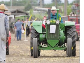 A competitor in the Turtle Race, in which the drivers of old tractors vie to cross the finish line last, during Pion-Era at the Western Development Museum on Sunday.