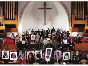 Congregants at the Metropolitan African Methodist Episcopal Church in Washington, D.C., hold photographs of the nine victims killed at Charleston, S.C.'s Emanuel African Methodist Episcopal Church earlier this week.