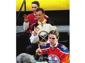 Connor McDavid, foreground, first-overall pick, Jack Eichel, centre, second-overall pick, and Dylan Strome, third-overall pick, pose during the first round of the NHL draft Friday.