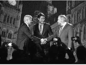Conservative Leader Stephen Harper, left, and NDP Leader Tom Mulcair shake hands as Liberal Leader Justin Trudeau looks on ahead of the Sept. 17 debate in Calgary. For Canadians, the Oct. 19 vote comes down to picking a leader - that's the only big decision left, writes Michael Den Tandt.