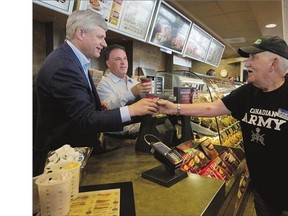 Conservative Leader Stephen Harper serves coffee as he stops at a Tim Hortons in Gananoque, Ont., in August.