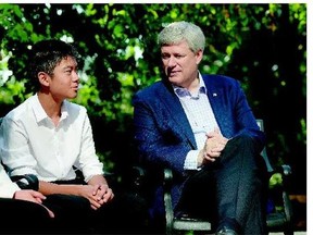 Conservative Leader Stephen Harper speaks Tuesday with Jennifer Ip, left, and her son Cameron Li, in Markham, Ont. where Harper said he wouldn't introduce any policies that would condone or normalize the use of illegal drugs.