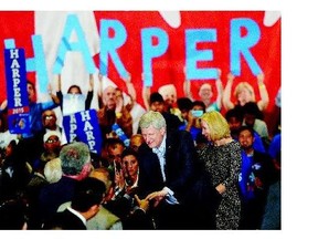 Conservative Leader Stephen Harper and his wife, Laureen, shake hands with supporters during a rally in Ontario.