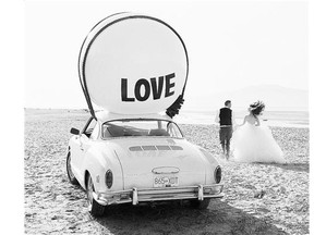 A couple is photographed with the Big Love Ball. Photo sharing has largely been the reason word of the inflatable sculpture has spread so quickly.