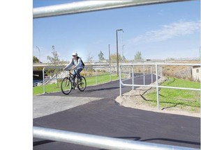 A cyclist tries out the new path open to the public along the Meewasin Trail at the foot of the Idylwyld Bridge on Saturday.