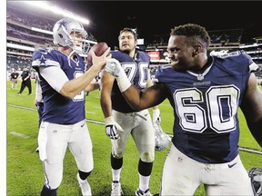 Dallas Cowboys' Brandon Weeden, left, celebrates with Davon Coleman following Sunday's 20-10 win over the Philadelphia Eagles on Sunday. Weeden was forced into the lineup after an injury to starting quarterback Tony Romo.