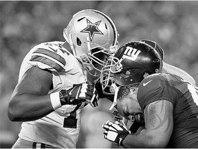 Dallas Cowboys tackle Tyron Smith, left, and New York Giants defensive tackle Cullen Jenkins lock helmets during NFL action. The Giants bring an 0-2 record into the Thursday night game against the 1-1 Washington Redskins.