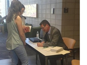 David Milgaard, who was wrongfully convicted of murder, can be seen signing books and speaking with students at the University of Saskatchewan College of Law. Milgaard was on campus as part of a panel discussion on wrongful imprisonment, which took place at the college on Wednesday, there he renewed his call for an independent body to review  convictions in Canada.