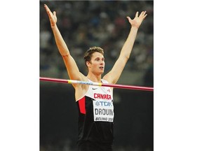 Derek Drouin reacts after a successful jump in the men's high jump final at the world championships in Beijing Sunday.