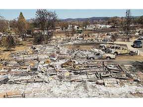 Destroyed homes and vehicles scorched by the Valley fire line Jefferson St. in Middletown, Calif., on Monday.
