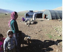 Displaced Iraqis from the Yazidi community stand in front of tents on Mount Sinjar, 160 kilometres west of the northern city of Mosul.