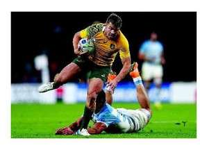 Drew Mitchell of Australia runs clear from Lucas Gonzalez Amorosino of Argentina during World Cup Rugby semifinal action Sunday in London. The Aussies won 29-15 to earn their way into Saturday's final against the New Zealand All Blacks.