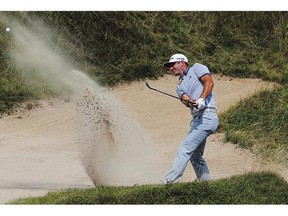 Dustin Johnson plays a bunker shot during the PGA Championship Sunday.