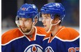 Edmonton Oilers' Anton Slepyshev, left and Connor McDavid speak during a break against the Minnesota Wild's during the first period of an NHL pre-season hockey game in Saskatoon, Sask., on Saturday, September 26, 2015.