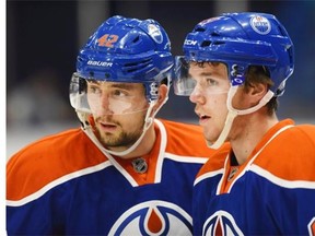 Edmonton Oilers' Anton Slepyshev, left and Connor McDavid speak during a break against the Minnesota Wild's during the first period of an NHL pre-season hockey game in Saskatoon, Sask., on Saturday, September 26, 2015.