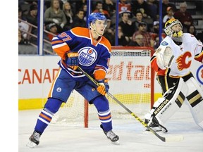 Connor McDavid #97 of the Edmonton Oilers looks for a pass in front of goalie Mason McDonald of the Calgary Flames at Rexall Place on Sept. 21, 2015 in Edmonton.