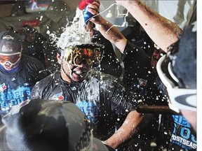 Edwin Encarnacion of the Toronto Blue Jays and teammates celebrate in the clubhouse after defeating the Baltimore Orioles and clinching the AL East Division following game two of a doubleheader on Wednesday.