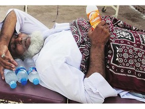 An elderly man suffering from heatstroke waits for a medical help at a hospital in Karachi, Pakistan, Friday. The devastating heat wave that struck southern Pakistan last weekend is slowly subsiding but the toll was still climbing Thursday, to a total of 860 deaths.