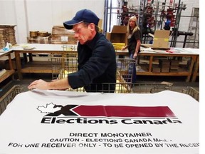 Elections Canada worker Phil Newton assembles a skid with boxes of supplies for poling stations in Ottawa.