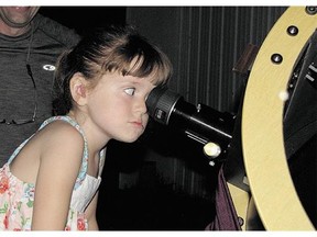 Elizabeth 'Lizzy' Myers, 5, gazes through a telescope at the Warren Rupp Observatory in Bellville, Ohio.