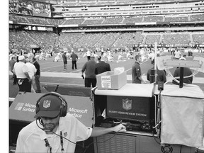 An NFL employee demonstrates a video review system used to spot injuries on the field at Met Life Stadium.