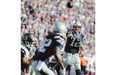 New England Patriots quarterback Tom Brady throws a touchdown pass to wide receiver Keshawn Martin in the second half against the Jacksonville Jaguars, Sunday. Brady surpassed the 400-touchdown milestone during New England's 51-17 victory.