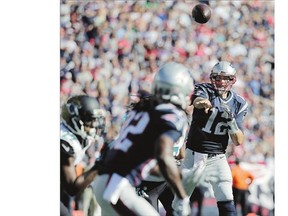 New England Patriots quarterback Tom Brady throws a touchdown pass to wide receiver Keshawn Martin in the second half against the Jacksonville Jaguars, Sunday. Brady surpassed the 400-touchdown milestone during New England's 51-17 victory.