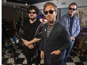 In this Aug. 18, 2015 photo, Dan Auerbach, center, Richard Swift, left, and Leon Michels pose at Easy Eye Studio in Nashville, Tenn. Black Keys guitarist and singer Dan Auerbach brought together studio musicians with diverse backgrounds in rock, soul, Latin and country for his new band, The Arcs. Their debut album, “Yours, Dreamily,” out on Sept. 4, is a funky, synthesizer-heavy collection of garage rock songs as varied as the musicians involved. (Photo by Wade Payne/Invision/AP)