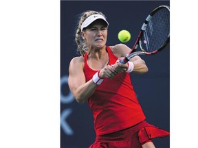Eugenie Bouchard of Westmount, Que. plays a shot against Belinda Bencic of Switzerland during action at the Rogers Cup in Toronto on Tuesday. Bouchard lost in three sets.