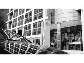 The exterior of the CBC building and its reflections in a parked vehicle in Toronto. The company plans to reduce its real estate footprint by 50 per cent,