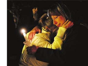 Family and friends of missing two-year-old Hailey Dunbar-Blanchette react at a candlelight vigil after being told the Amber Alert had been officially cancelled and that human remains had been found on Tuesday.