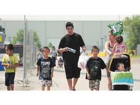 A family from Sturgeon Lake, Sask. walks toward a swimming pool in Regina on Monday.