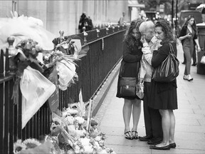 A family grieves at a memorial to victims of the July 2005 bus bombing near Tavistock Square on Tuesday in London.