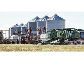 Farm machinery sits idle in a field north of Regina.