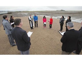 Father Kevin McGee, elder Celia Clennell and First Nations cultural leader Delvin Kanewiyakiho conduct a blessing of the Rosewood joint-school site on Wednesday.