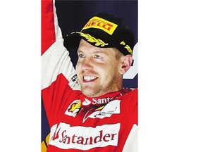 Ferrari driver Sebastian Vettel of Germany celebrates winning the Singapore Formula One Grand Prix Sunday.