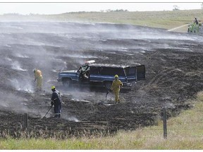 Firefighters from Saskatoon and Delisle battle a blaze along Highway 60 on the way to Pike Lake, approximately one kilometre south of St. Volodymyr's Ukrainian Park on Wednesday. As of Tuesday, there were 113 active fires in the province, according the Ministry of Environment.