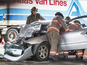 Firefighters work to free a passenger from a car involved in a collision with a truck under the 51st Street overpass on Monday. At least one person was sent to hospital after Saskatoon police reported two separate collisions in the city Monday. The first collision occurred at Clarence Avenue and Fifth Street East at 8:45 a.m., when a truck struck a man who was on foot. The pedestrian was taken to hospital by MD Ambulance with what are believed to be non-life-threatening injuries. Emergency crews were at the scene of a second collision at 9 a.m. at Idylwyld Drive and 51st Street where an occupant of a car was trapped after a collision with a truck. There is no word on the extent of the injuries in the second incident.