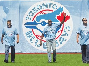 Former Blue Jays George Bell, left, Lloyd Moseby and Jesse Barfield, members of the Blue Jays 1985 division championship team, walk in from the outfield for a pre-game ceremony honouring that team prior to the start of Sunday's game against the Yankees in Toronto.