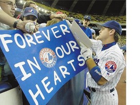 Former Montreal Expos first baseman Brad Wilkerson signs autographs before the team's final home game against the Florida Marlins in Montreal on Sept. 29,2004.