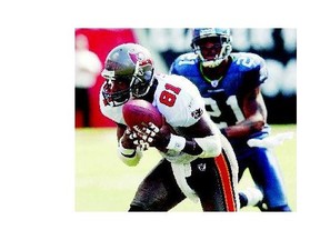 Former Oakland Raiders wide receiver Tim Brown, left, shown here playing for the Tampa Bay Buccaneers in his final season, had the versatility and longevity that made him a strong candidate for the Pro Football Hall of Fame, to which he was elected this year.